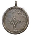 Silver medal depicting a leafless oak tree with three branches, each of which bears a crown