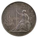 Silver medal depicting a draped woman seated in a rocky outcrop, one hand resting on a shield e…