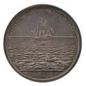 Silver medal of a ship, full-rigged and flying the flag of St. George, in a sea of wreckage, th…