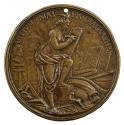 Bronze medal of a draped nude figure with wings on her head standing with one foot on a pedesta…