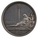 Silver medal of a nude woman with long hair, reclining on her left side against a pile of stone…