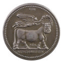 Silver medal of a bull with the head of a bearded man, walking, in profile to the right, being …