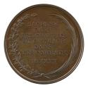 Bronze medal with an oak branch and palm branch tied into a wreath around the inscription