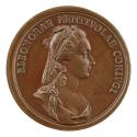 Bronze medal of a woman in profile to the right, her hair drawn back and braided