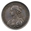 Silver medal of a woman in profile to the left with her hair loosely tied back, wearing a pearl…