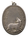 Silver medal of a lamb facing right and looking up to a sun