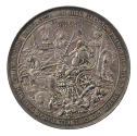 Silver medal of a king represented as a skeleton, holding a book and a sword and seated on a tr…