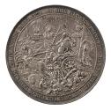 Silver medal of a king represented as a skeleton, holding a book and a sword and seated on a tr…