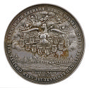 Silver medal depicting a crowned eagle holding scepter and sword in clouds above a walled citys…
