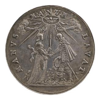 Silver medal depicting a man and woman holding hands beneath a radiant dove, while two hands em…