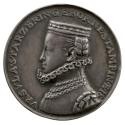 Silver medal of a woman with braided hair pulled into flat cap wearing armor, a high ruff colla…