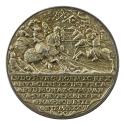 Silver medal of men fighting on horseback with inscription underneath