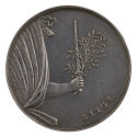Silver medal of depicting a child’s arm holding a sword with an olive branch emerging from a cu…