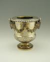 Gold and silver wine cooler with plant designs and rams' heads