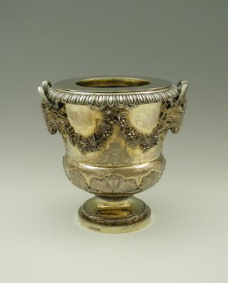 Gold and silver wine cooler with plant designs and rams' heads