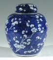 Single blue porcelain covered jar decorated with white floral decorations.