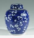 Single blue porcelain covered jar decorated with white floral decorations.