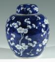 Single blue porcelain covered jar decorated with white floral decorations.