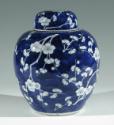 Single blue porcelain covered jar decorated with white floral decorations.