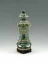 Porcelain jar with legs and lid with green, blue, and yellow pattern decoration