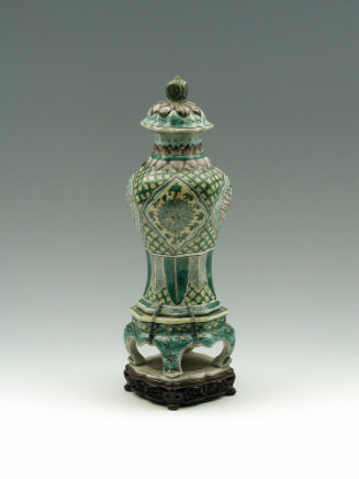 Porcelain jar with legs and lid with green, blue, and yellow pattern decoration