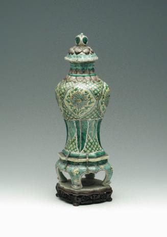 Porcelain jar with legs and lid with green, blue, and yellow pattern decoration