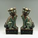 Pair of green porcelain lions, viewed from the front