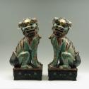 Pair of green porcelain lions, viewed from the side