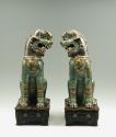 Pair of green porcelain lions, viewed from the front