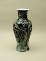 Black ground porcelain vase with branches and white flowers