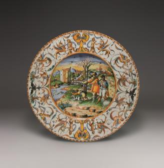 Circular plate with a central scene and large border of ornate decoration, in color