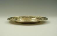 Gilt silver plate with plant and floral design at rim