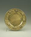 Gilt silver plate with plant and floral design at rim, front view