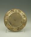 Gilt silver plate with plant and floral design at rim, back view