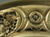 Gilt silver plate with plant and floral design at rim, detail of rim