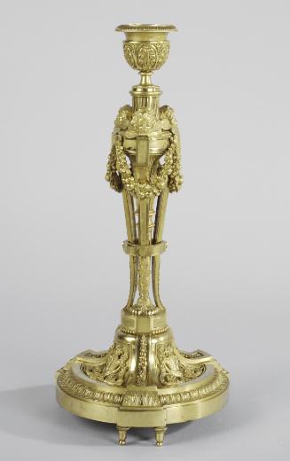 Gilt bronze candlestick with cherub heads and swags of garland