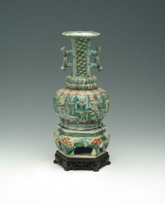 Green porcelain jar with handles and floral and vegetal designs