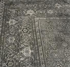 Black and white image of corner portion of Persian carpet with floral design