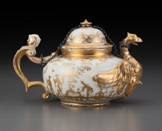 Elongated teapot with gold and a griffin spout