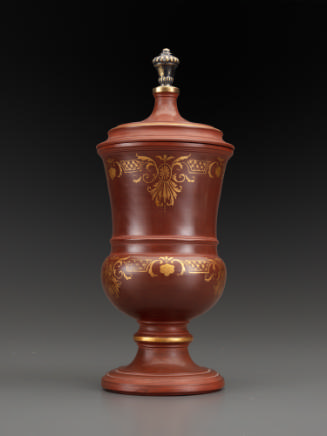 large brown beaker with gold decoration