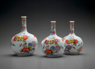 Three large bottle-shaped vases with floral decoration