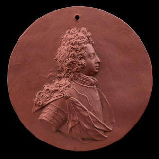 brown, circular medallion with profile portrait