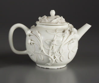 white teapot with floral relief decoration