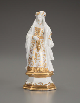 White porcelain figurine of a female with gilt decoration