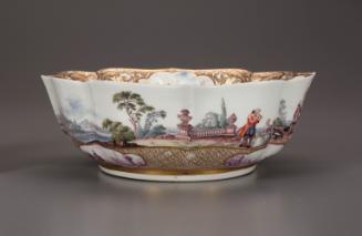 Side view of a bowl with a painted scene and gilt decoration