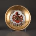 Saucer with a crest and landscape scene painted at the center with gilt decoration