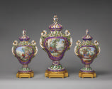 Three porcelain pot-pourri vessels in purple and green with landscape scenes