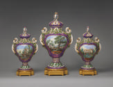 Alternate view of three porcelain pot-pourri vessels in purple and green with landscape scenes