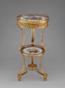 View of tripod table from the side made with two circular plaques of Sevres porcelain held toge…