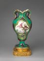 Porcelain vase with ear-like forms and with images of birds in trees on a gilt bronze base